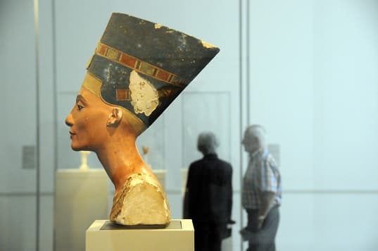 Side view of the unfinished Nefertiti bust, an ancient Egyptian sculpture.