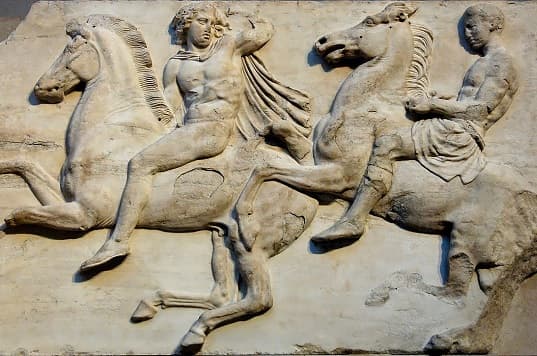 Image of Cavalry from the Parthenon Frieze, West II, 2-3, a relief sculpture depicting Greek soldiers on horseback engaged in battle.