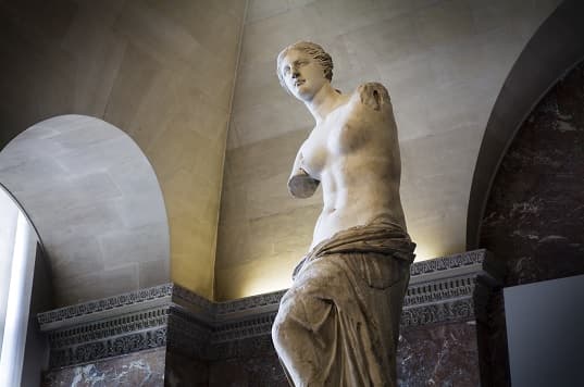 Photo of the Venus de Milo, a famous ancient Greek marble sculpture of a Greek goddess in a contrapposto pose.