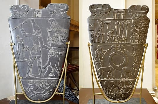 A display of the Narmer Palette replica at the Egyptian Museum in Cairo, Egypt, with front and back sides visible.