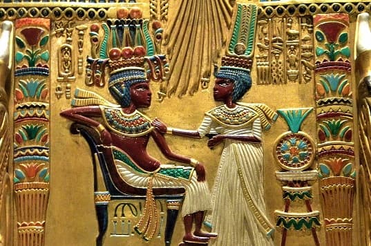 Close-up view of the center of the Throne of Tutankhamun, depicting intricate gold and precious stone detailing.